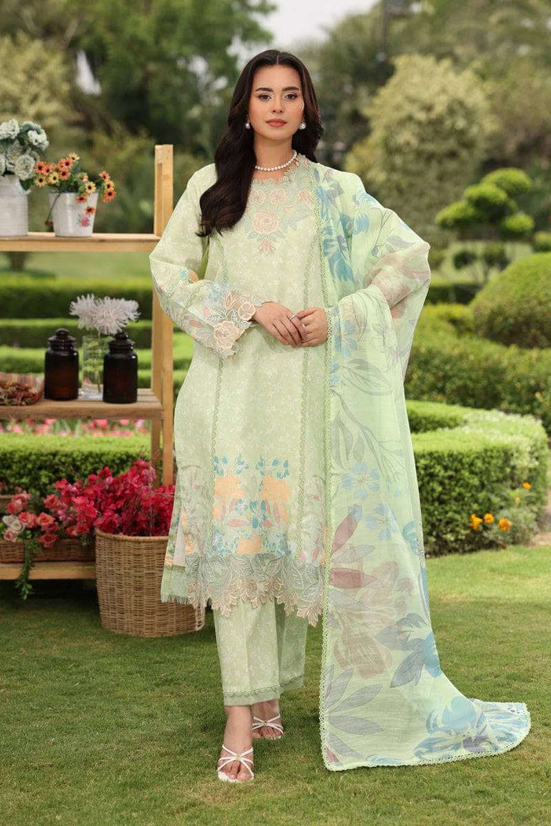 Woman in a light green floral outfit standing in a garden