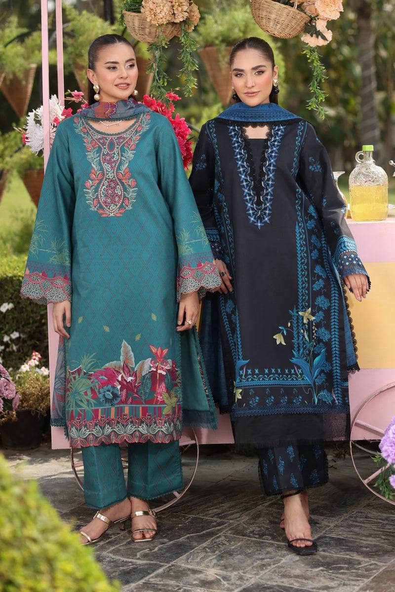 Two women in traditional embroidered outfits standing outdoors with floral decorations.