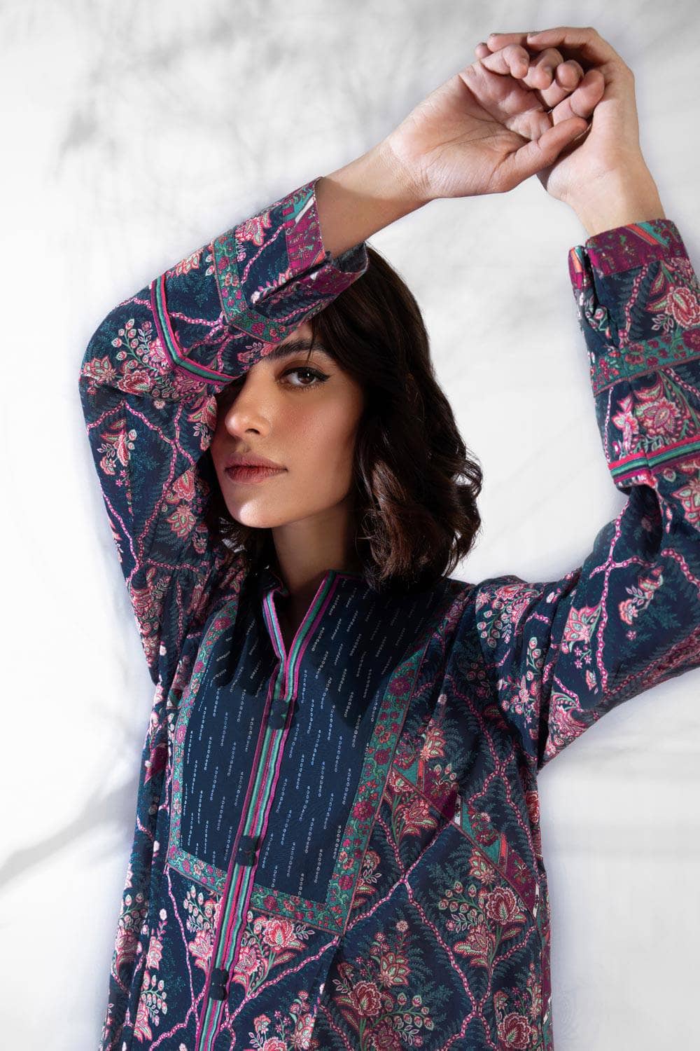 Don't be afraid to make a splash in this colourful geometric print! This unstitched three piece outfit features a lightly embroidered printed lawn shirt, voile dupatta and cotton trousers. Product Detail Unstitched 3-Piece Shirt Embroidered Neckline 1PC Embroidered Border 1PC Printed Lawn Shirt 3M Fabric: Lawn Color: Multi
