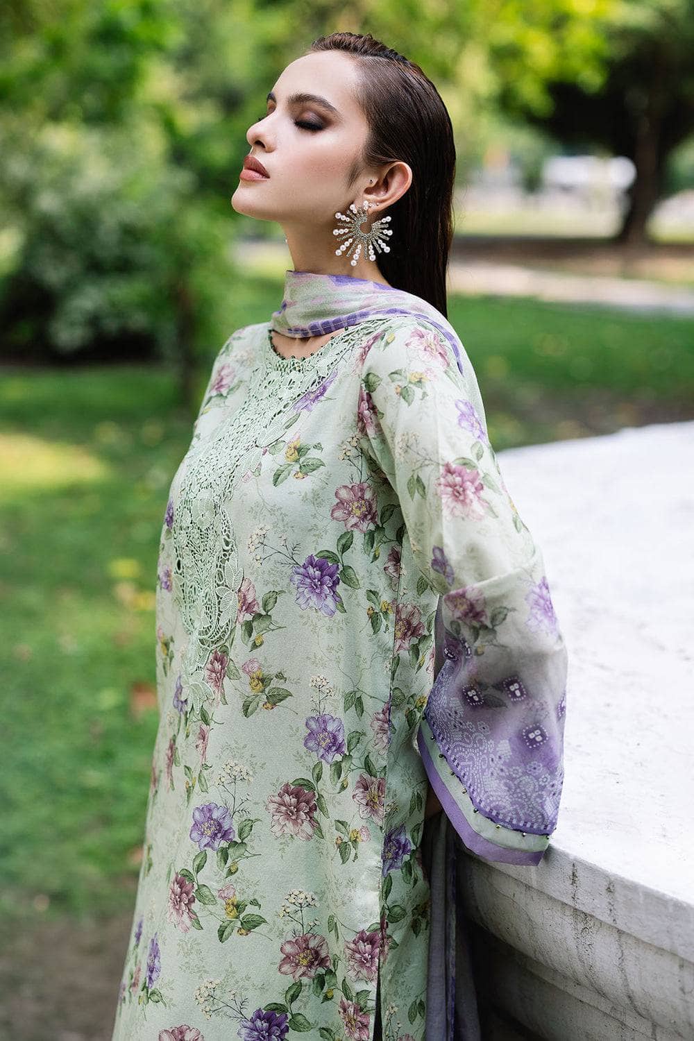 Woman wearing a floral dress with a blurred outdoor background