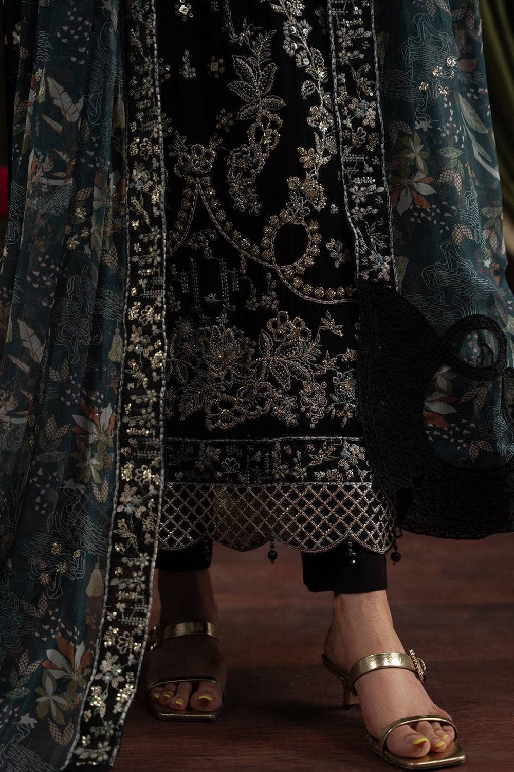 Traditional embroidered outfit with floral patterns on a dark background