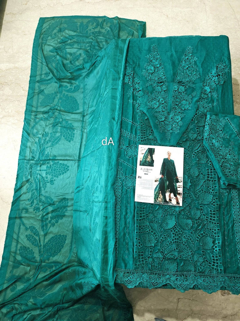 Teal embroidered fabric with a small product image on a neutral background