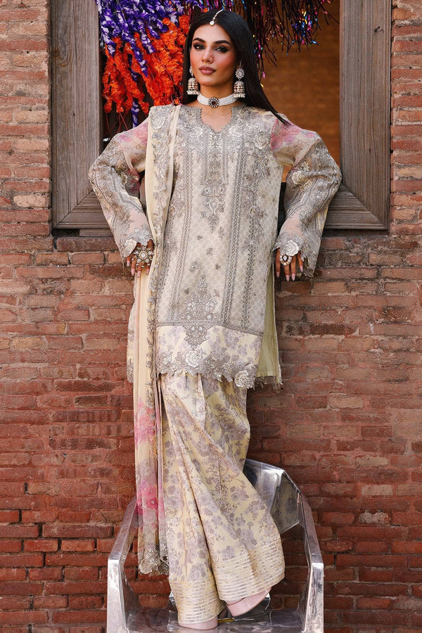 Woman in traditional outfit standing against a brick wall with colorful flowers in the background