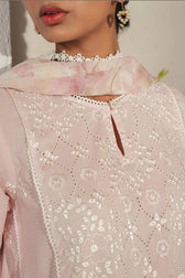 Close-up of a light pink embroidered garment with floral patterns.