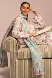 Woman in floral outfit sitting on a striped chair holding a book.