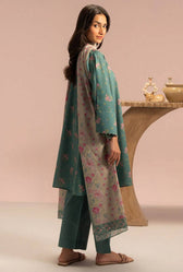 Woman wearing a teal floral outfit with a pink background