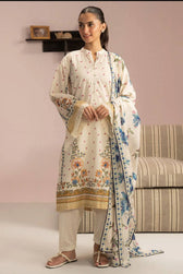 Woman wearing a traditional outfit with a floral shawl in a room setting.