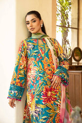 Woman wearing a colorful floral dress with a matching scarf indoors.