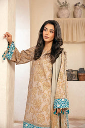 Woman wearing a traditional outfit with floral patterns and blue accents in a neutral setting.