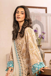 Woman wearing a traditional outfit with intricate patterns, standing indoors.