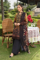Woman in traditional attire standing outdoors with garden and table in the background