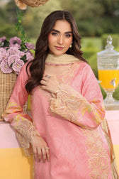 Woman in a pink embroidered outfit with flowers and a basket in the background